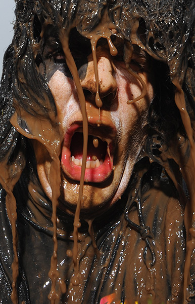 Tough Guy: A mud-spattered competitor at the Tough Guy Challenge 2012