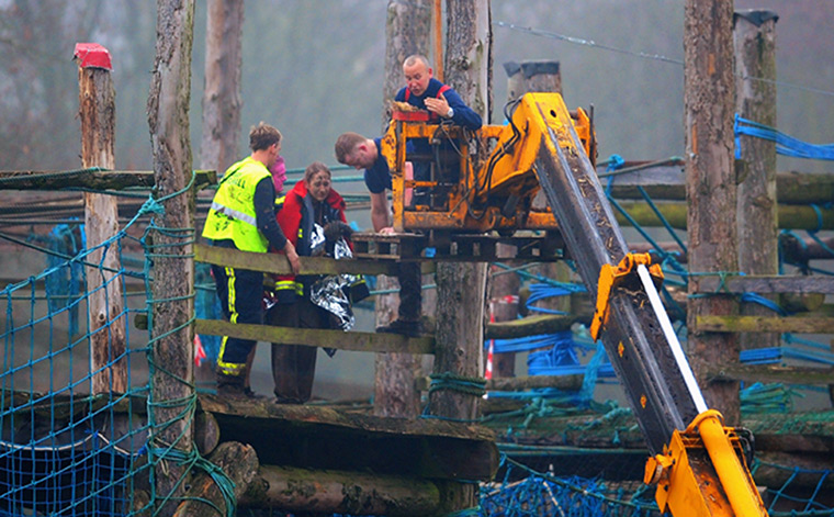 Tough Guy: A competitor is rescued by a crane during the Tough Guy Challenge 2012