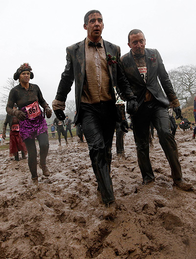 Tough Guy: Competitors walk through mud during the Tough Guy Challenge 2012