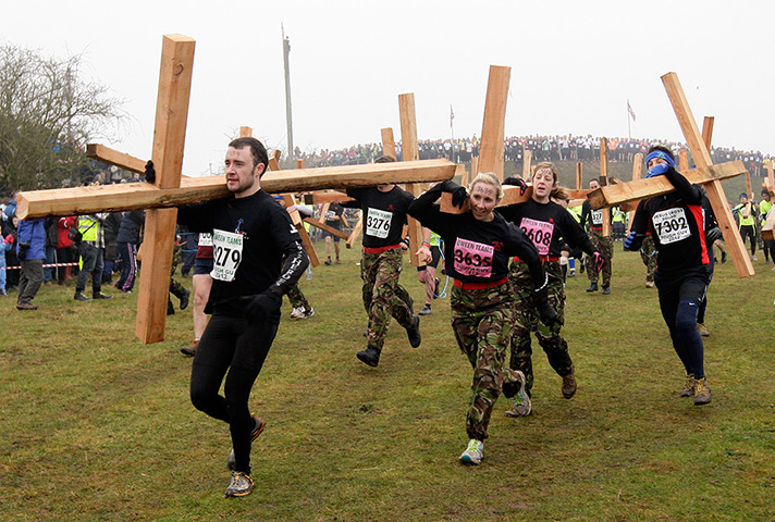 Tough Guy: Tough Guy 2012 competitors run with crosses