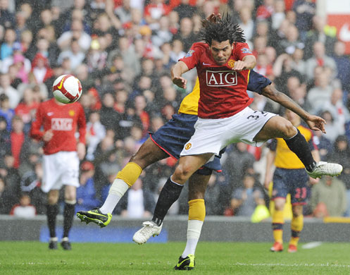 Man Utd. league champions: Carlos Tevez and Alexandre Song