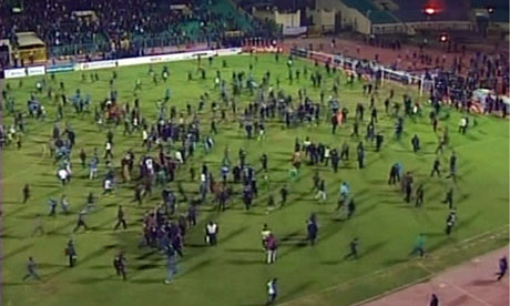 Fans rush the pitch during the riots that erupted after the match between Al-Masry and Al-Ahl