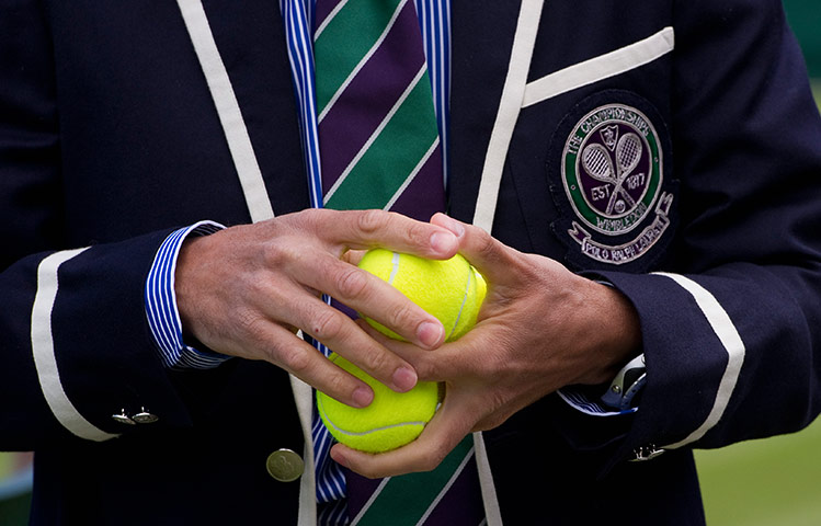 Wimbledon photo book: A referee checks the balls before a Wimbledon members test game on Court 2
