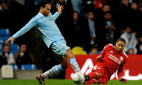 Glen Johnson of Liverpool, right, tackles Joleon Lescott of Manchester City