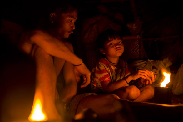 Mattias Klum gallery: Camp of nomadic Penan at night in Borneo's rainforest