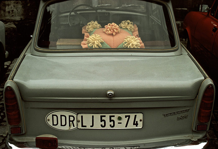 berlin vintage: Rear window of a 'Trabbi' (Trabant) car with decorative plastic cushion. 