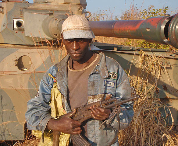 congo: Tank and armed local overlooking the village of Pweto