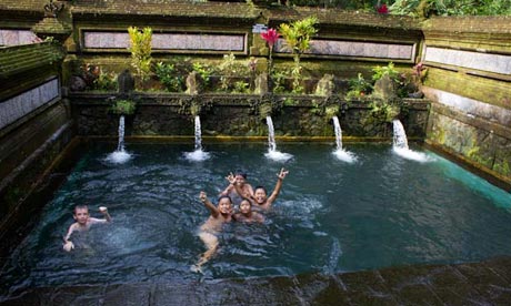 Local boys swimming in a spring-fed pool in Indonesia. 