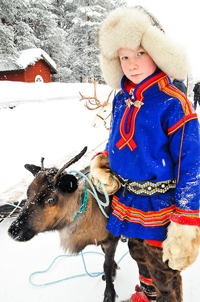 Sami Lapland: Sámi teenager and reindeer calf,  Jokkmokk