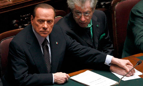 Silvio Berlusconi holds Northern League leader Umberto Bossi's hand in parliament